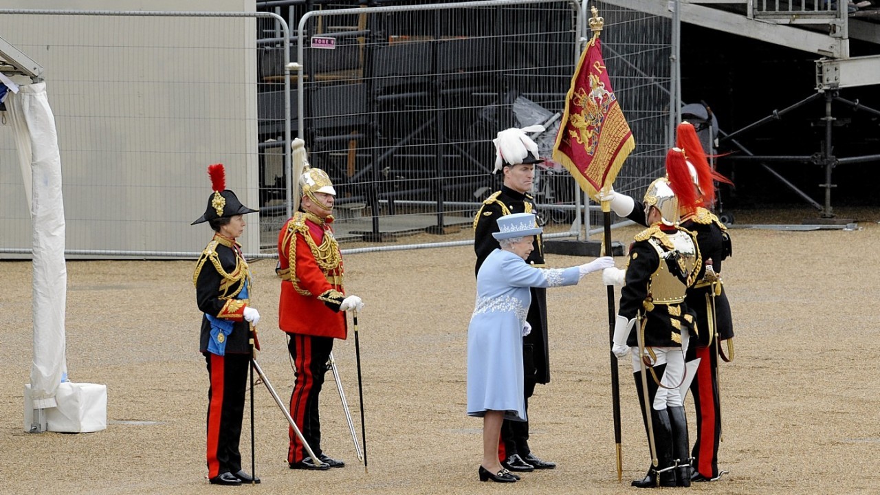 Handout photo issued by the Ministry of Defence of the Princess Royal (left) watching Queen Elizabeth II as she presents the Household Cavalry with new standards at Horse Guards Parade, London.