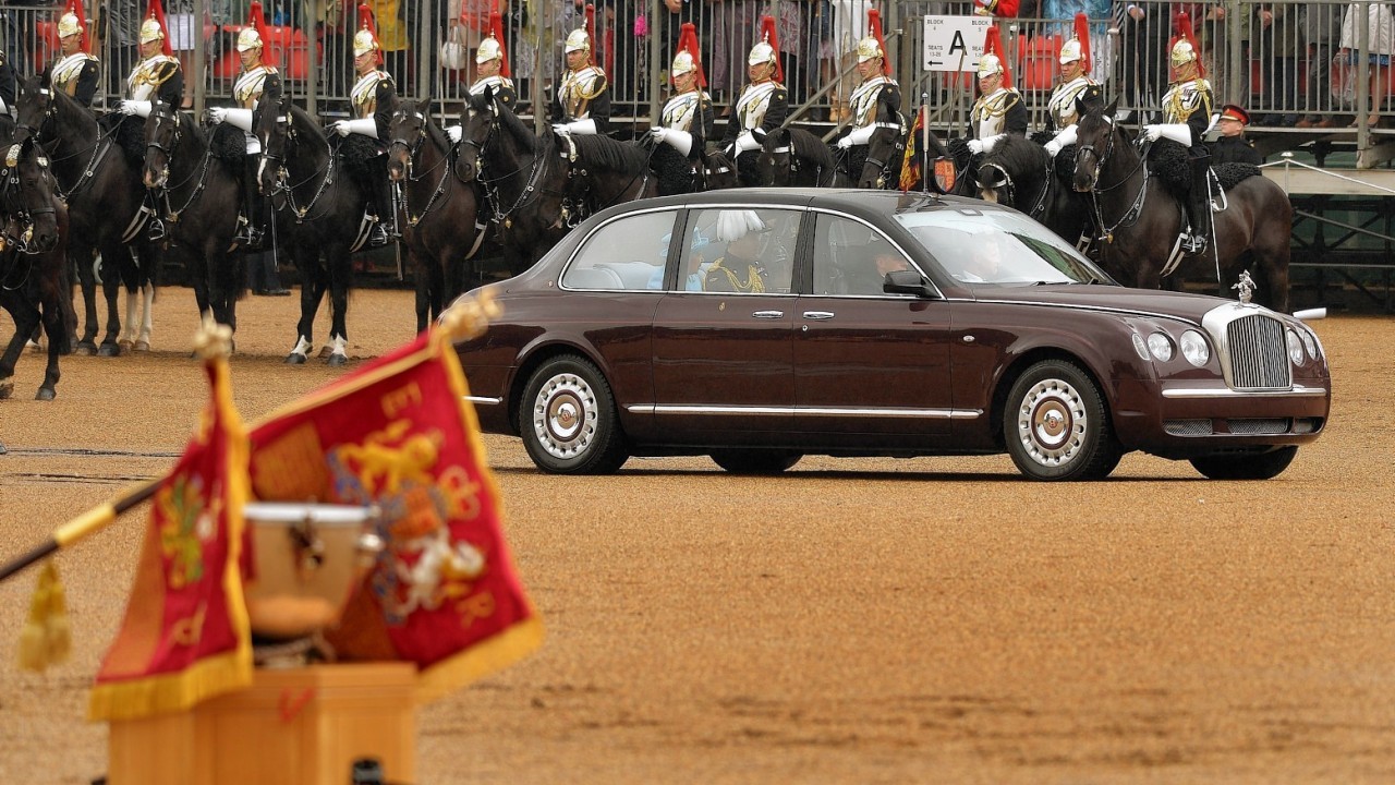 Queen Elizabeth II drives past members of the Household Cavalry before she presents them with new standards at Horse Guards Parade, London.