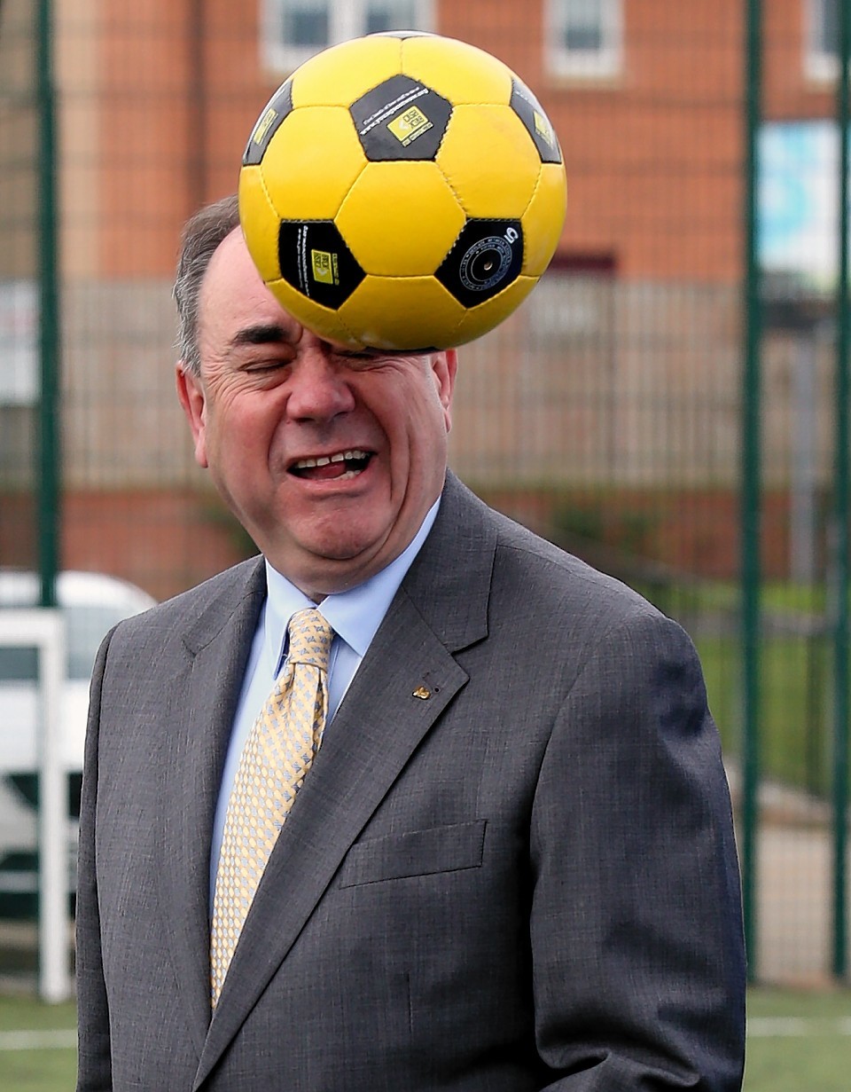 Scotland's First Minister Alex Salmond heads a ball during a Street Soccer Scotland photocall with Scotland under-21 midfielder Kenny McLean before the Scottish Cabinet meeting at Fernhill Community Centre in Rutherglen , the fifth in a series of meetings outside of Edinburgh following publication of Scotland's Future in November last year.