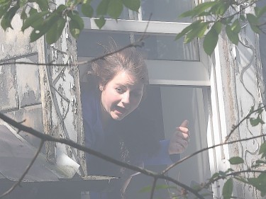 Smoke billows from the open window as Rachel screams for help