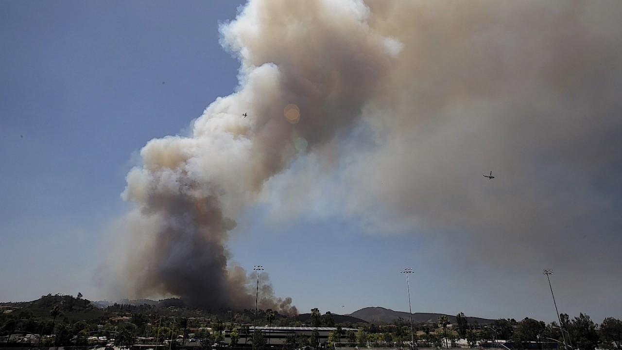 One of the nine fires burning in San Diego County suddenly flared Thursday afternoon and burned close to homes, trigging thousands of new evacuation orders.