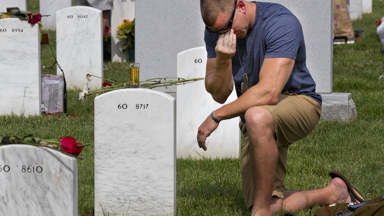 A man remembers in the Vicksburg National Cemetery following a Memorial Day observance