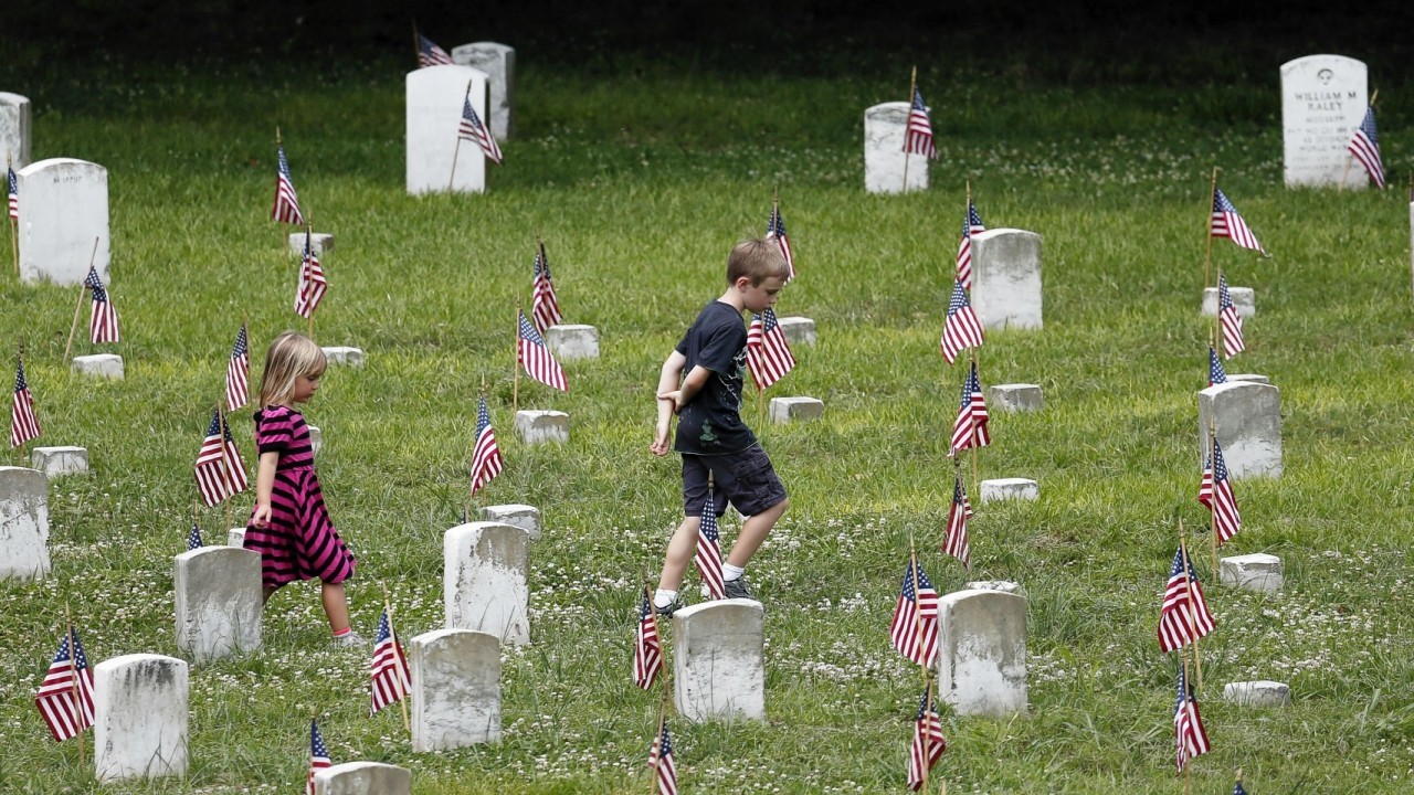 Children walk through the Vicksburg National Cemetery following a Memorial Day observance