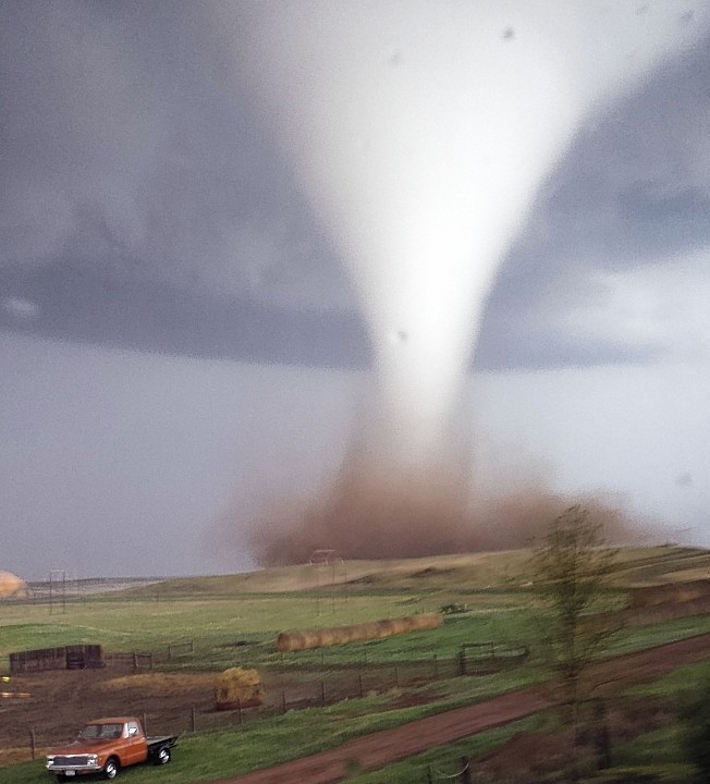 This photo taken on Monday, May 26, 2014 and provided by Jill Helmuth, shows a tornado touching down on a reach before heading towards Watford City, N.D. Authorities say several were injured and more than a dozen trailers were damaged or destroyed Monday evening when the twister tore through a camp where oil field workers stay