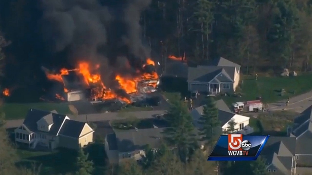 Local US TV images after a New Hampshire police officer was shot to death after he responded to a domestic disturbance at a home that later exploded and burned