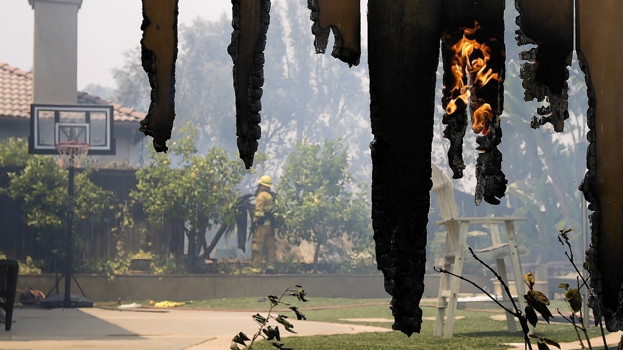 Flames engulfed suburban homes and shot up along canyon ridges in one of the worst of several blazes that broke out Wednesday in Southern California during a second day of a sweltering heat wave