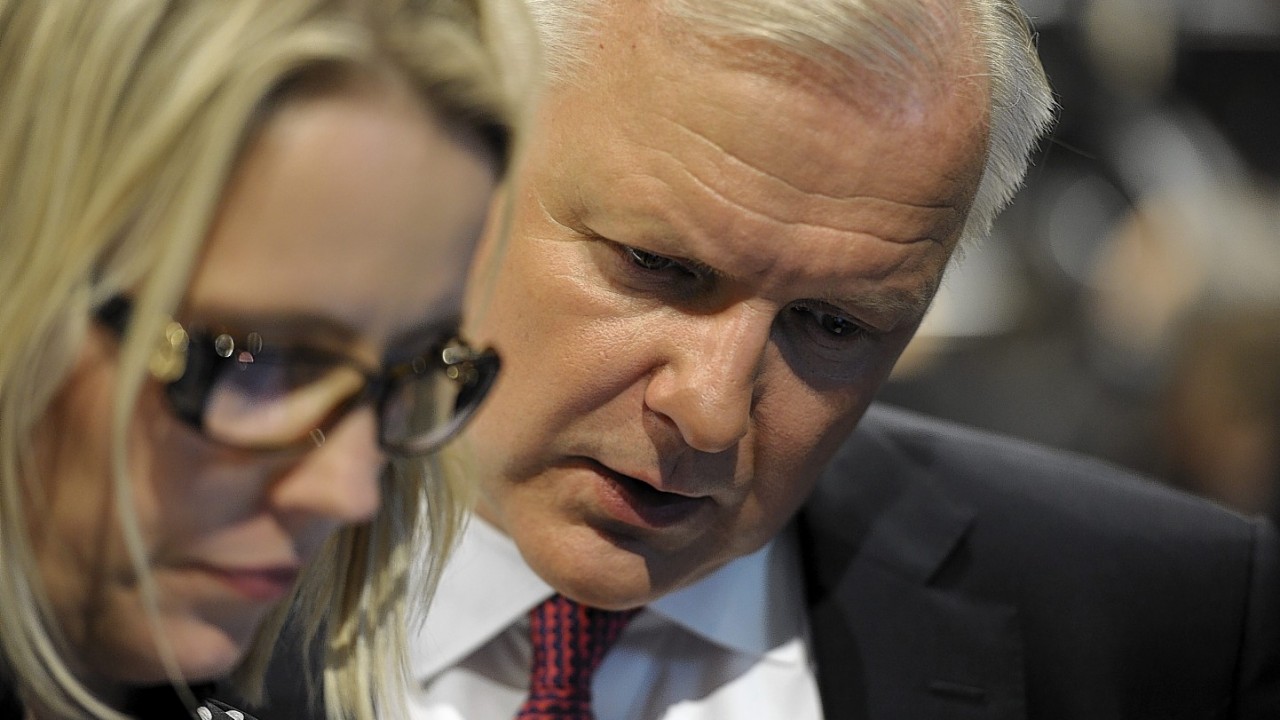 Finnish Centre Party candidate for the European Parliament Olli Rehn, right, talking to Riina Nevamaki from the Centre Party as they await results after the European Parliament elections at the Music Centre, in Helsinki,