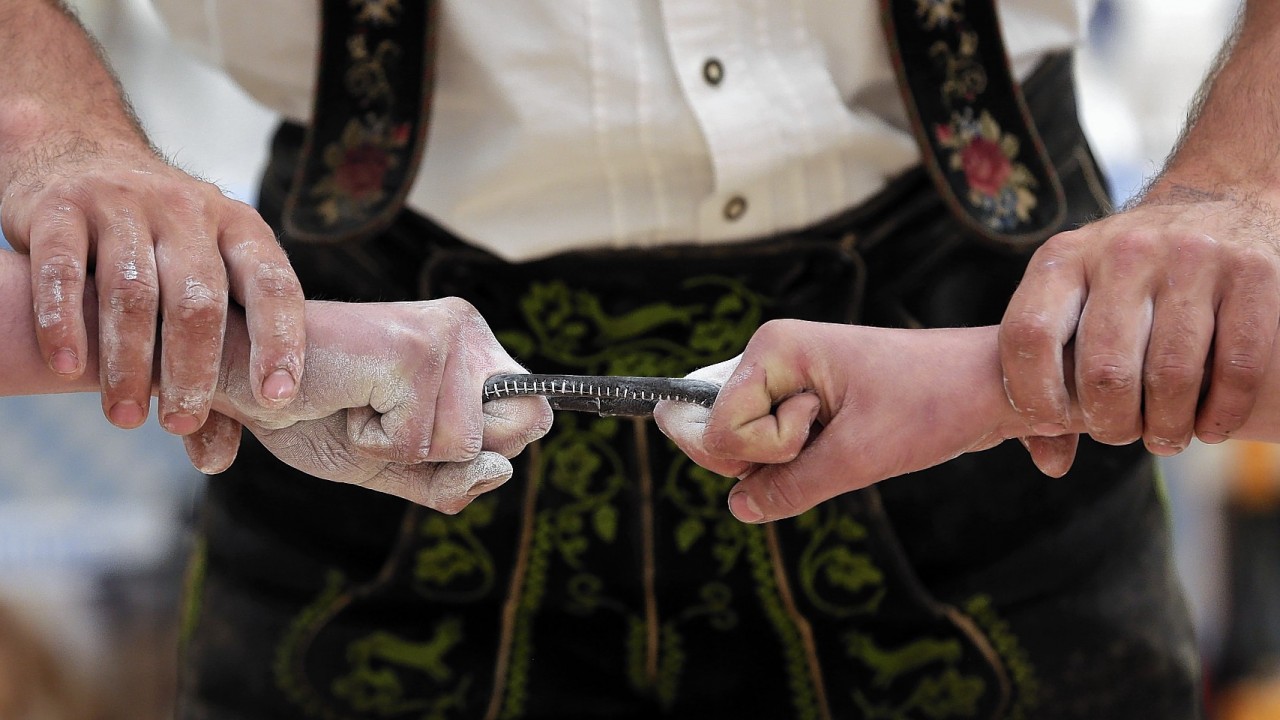 Two competitors prepare their middle fingers prior to a fight at the Alps Finger Wrestling championships in Reichertshofen, southern Germany