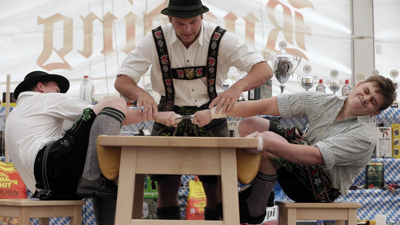 A judge watches the leather ring held by two competitors with their middle fingers at the Alps Finger Wrestling championships in Reichertshofen, southern Germany