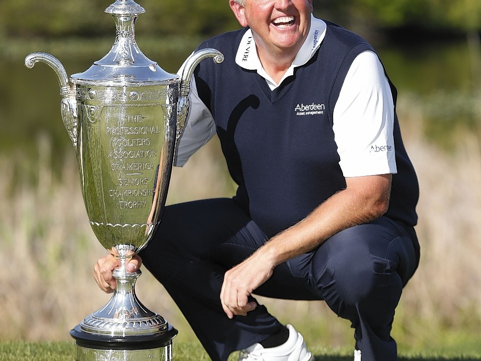 Colin Montgomerie poses with the Alfred S. Bourne trophy after winning the Senior PGA Championship golf tournament at Harbor Shores Golf Club in Benton Harbor, Michigan