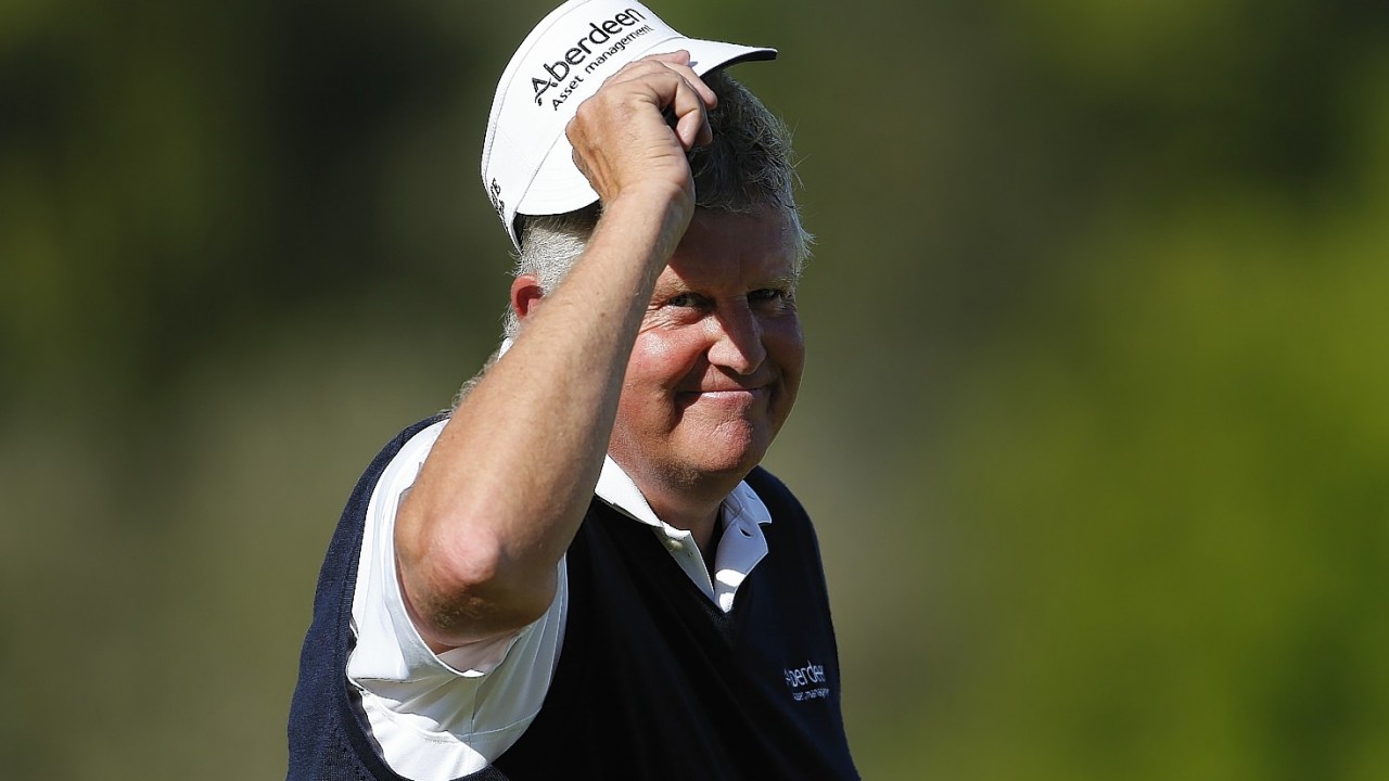 Colin Montgomerie tips his hat to the gallery on the 18th hole during the final round of the 75th Senior PGA Championship golf tournament at Harbor Shores Golf Club in Benton Harbor
