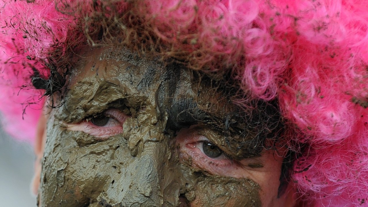 A competitor takes part in the Maldon Mud Race, a charity event on the River Blackwater in Maldon, Essex