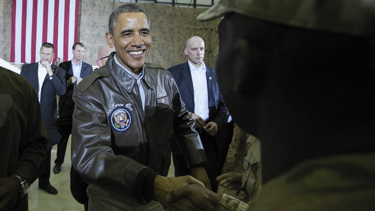 President Barack Obama shakes hands during a troop rally at Bagram Air Field, north of Kabul, Afghanistan, during an unannounced visit on Sunday, May 25, 2014.