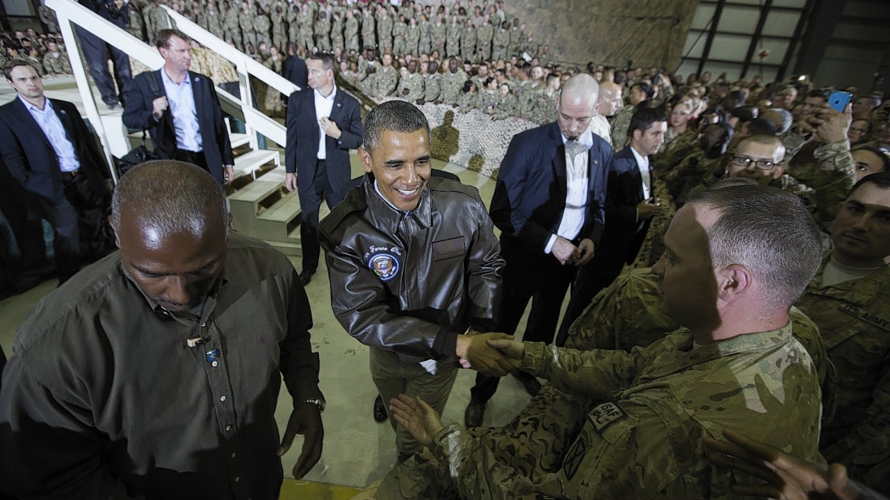 President Barack Obama shakes hands at a troop rally at Bagram Air Field, north of Kabul, Afghanistan, during an unannounced visit, on Sunday, May 25, 2014.