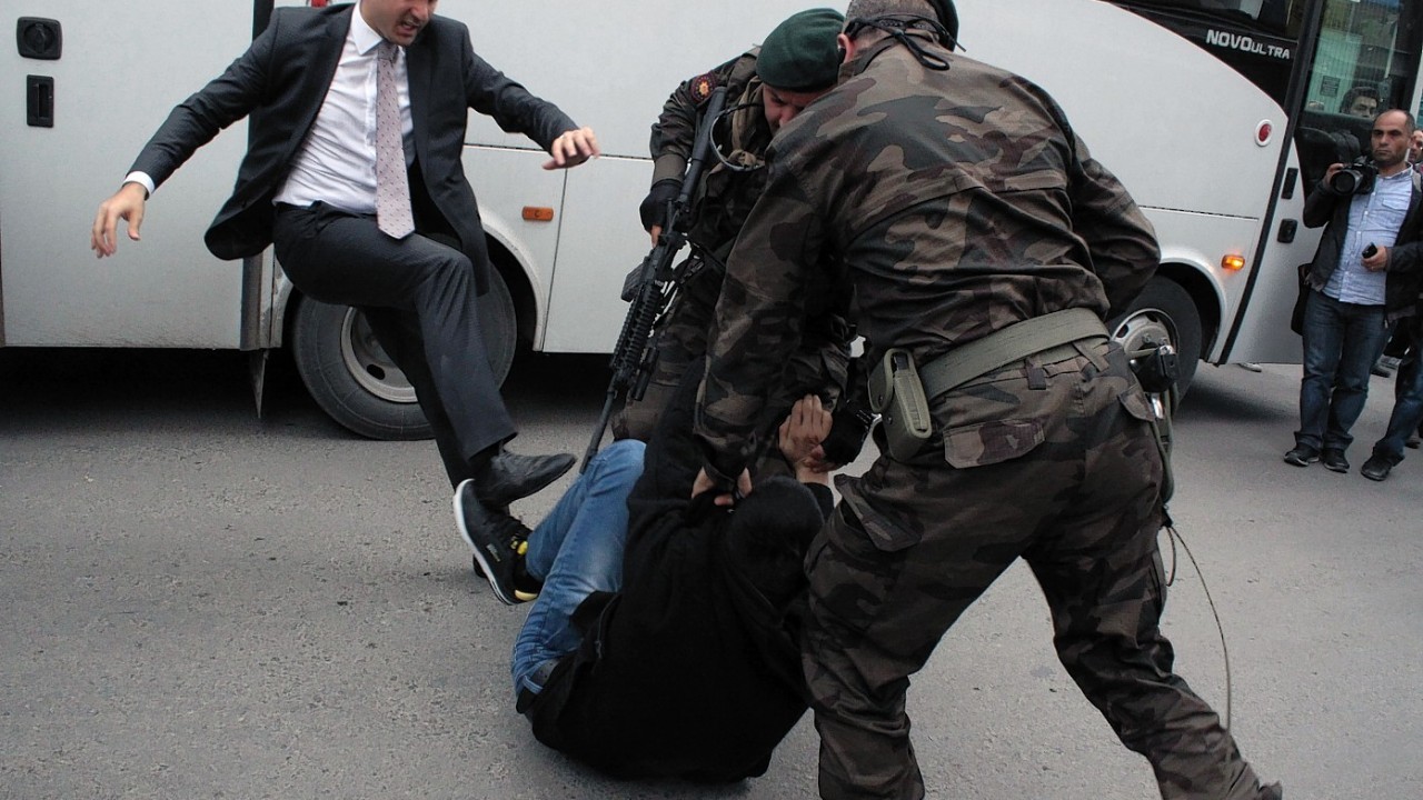 Yusuf Yerkel, advisor to Turkish Prime Minister Recep Tayyip Erdogan, kicks a protester already held by special forces police members during Erdogan's visiting  Soma, Turkey.