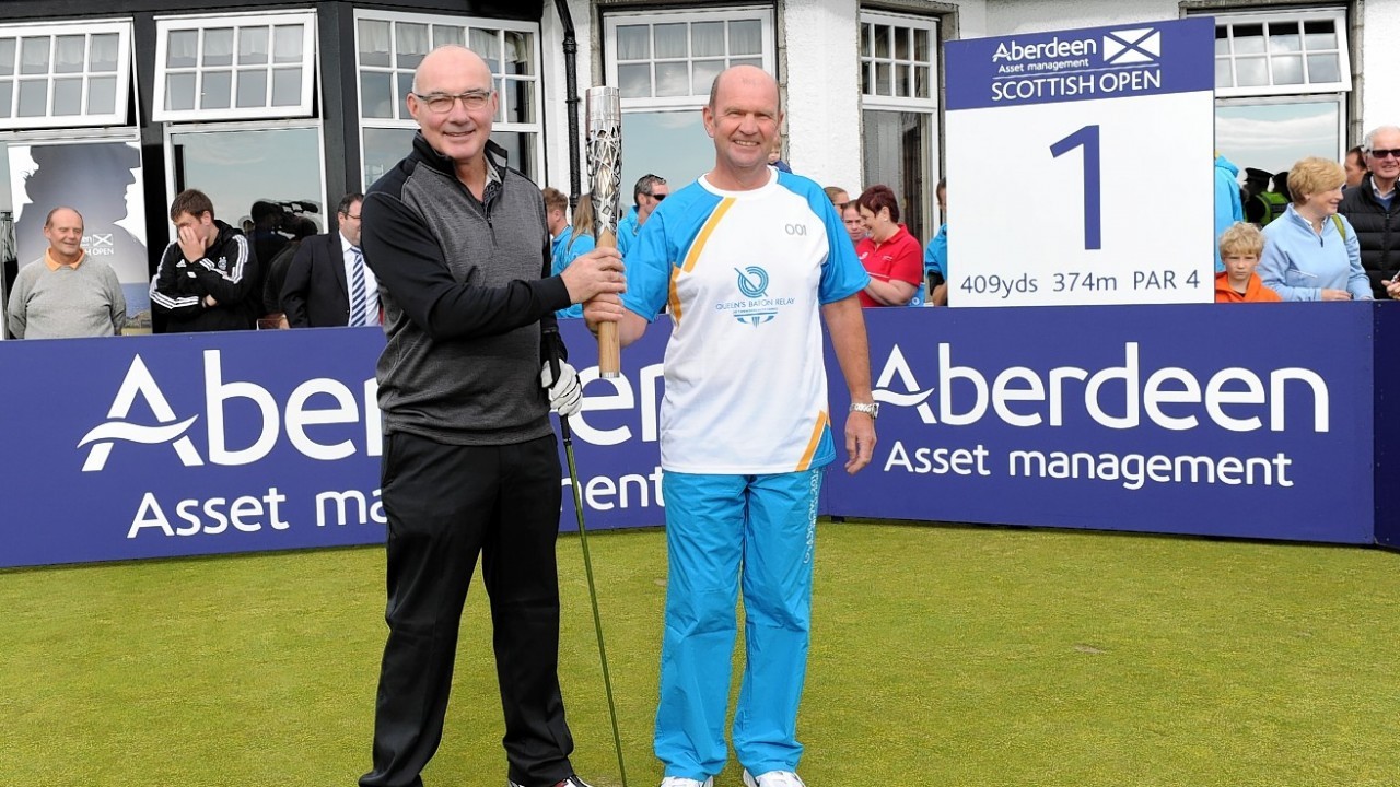 Willie Miller and Club captain Ian Morrison start the Queen's Baton Relay at Royal Aberdeen Golf.