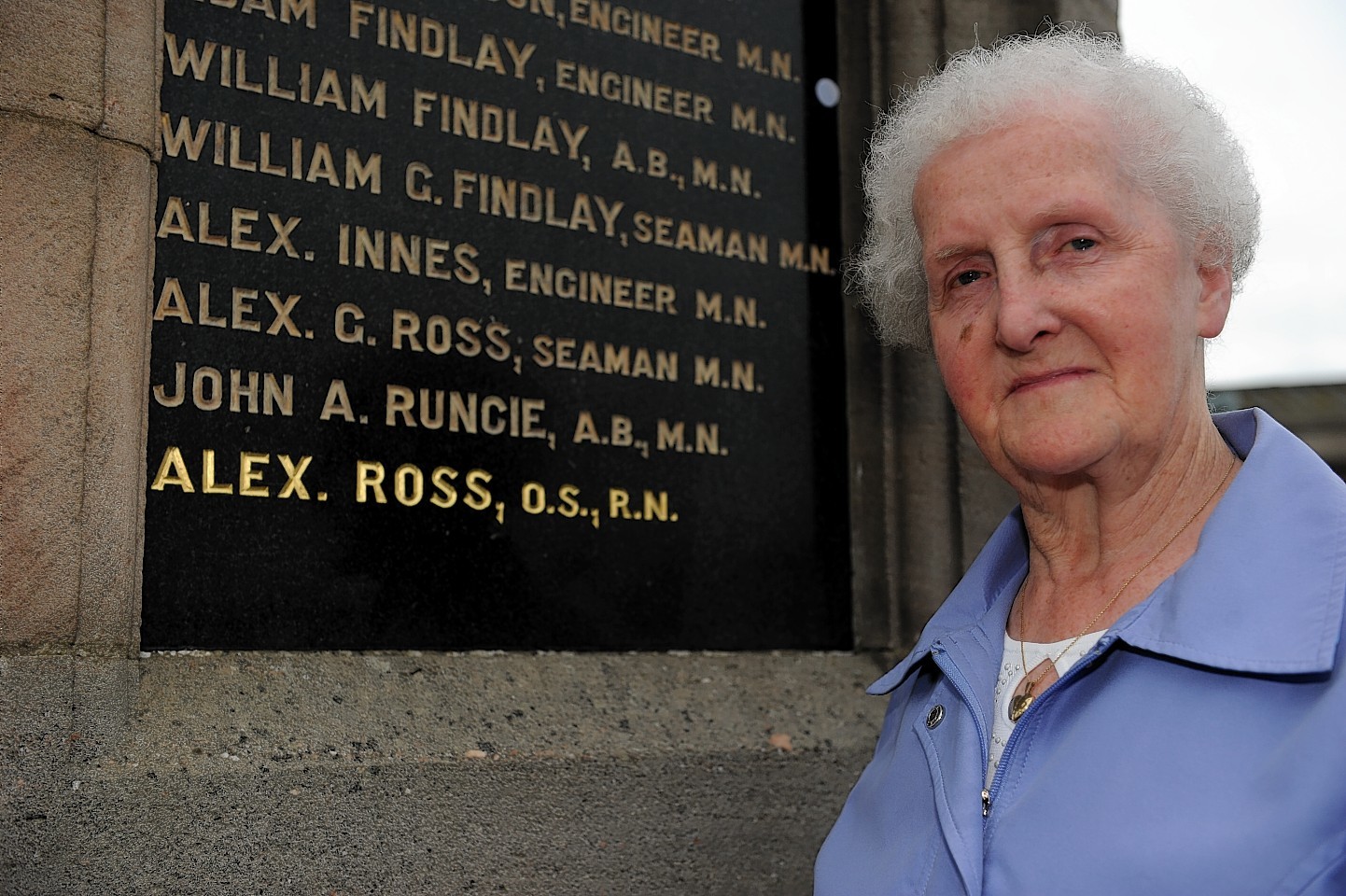 Isabel Ross next to the memorial to her cousin Alex Ross