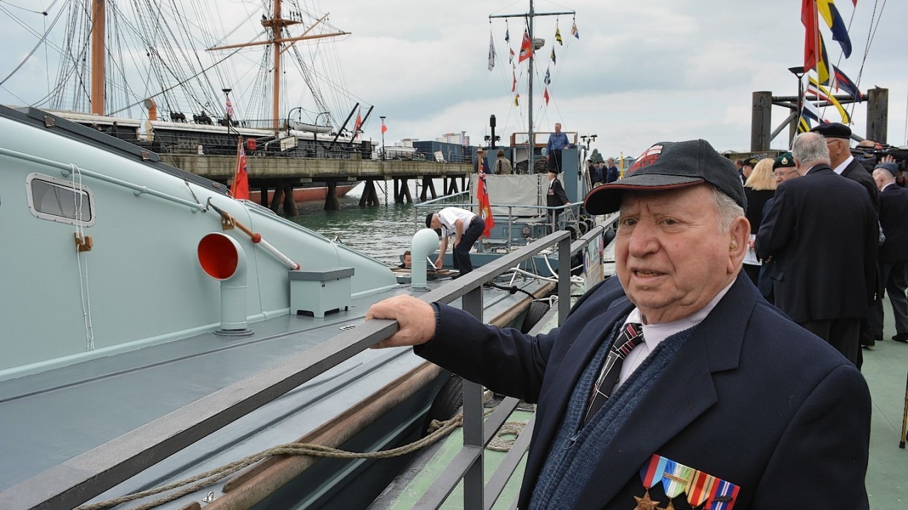 Basil Woolf, 91, from Dunedin, Florida, looks at the MGB81 which took part in the D-Day landings carrying British and Canadian troops to Sword Beach, during a visit to the Portsmouth Historic Dockyard ahead of the 70th anniversary of the D-Day campaign