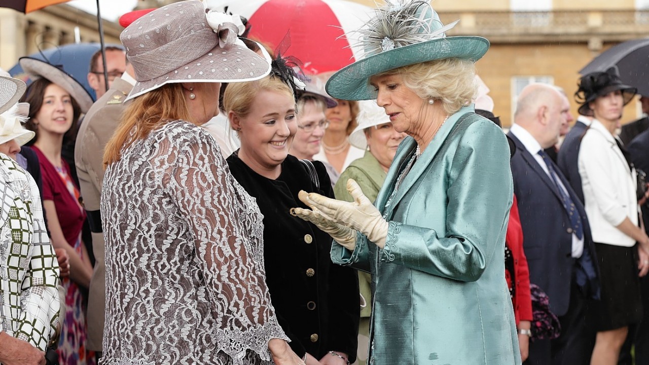 The Duchess of Cornwall meets guests during a garden party held at Buckingham Palace, central London.
