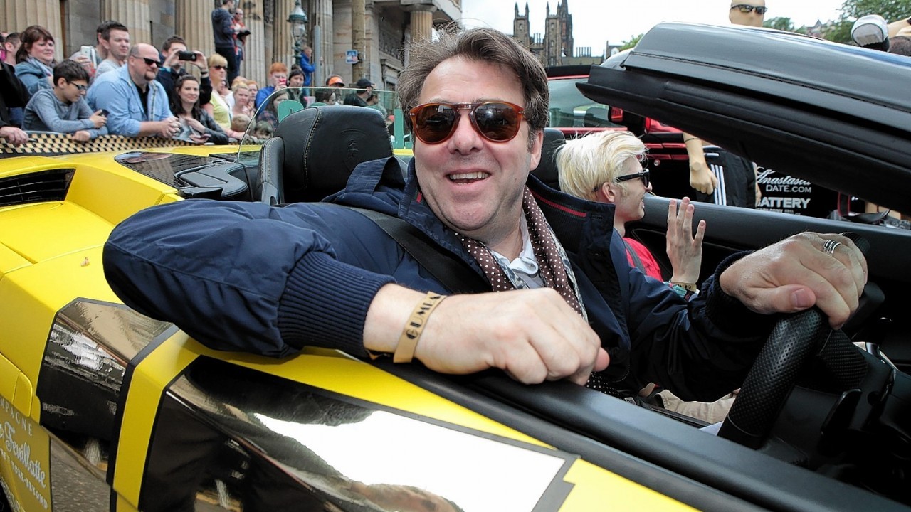 Jonathan Ross and his son Harvey in a yellow Lamborghini join other supercars as they set off from The Mound in Edinburgh and head to London on the next stage of the Gumball 3000.