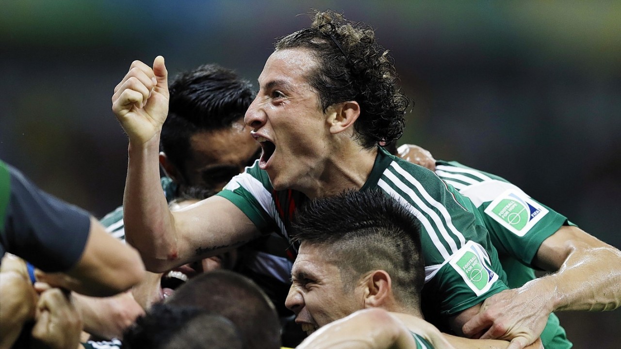 Mexico's Andres Guardado celebrates with teammates after Mexico's Rafael Marquez  scored his team's first goal during the group A World Cup soccer match between Croatia and Mexico at the Arena Pernambuco in Recife