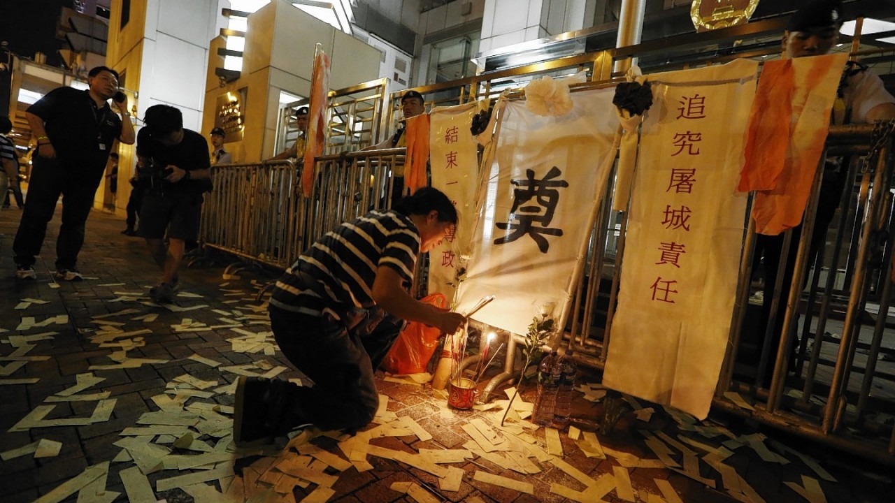 A protester prays for those killed during the China's crackdown on pro-democracy protests on Tiananmen Square on June 4, 1989 in Beijing, outside the Chinese liaison office in Hong Kong.