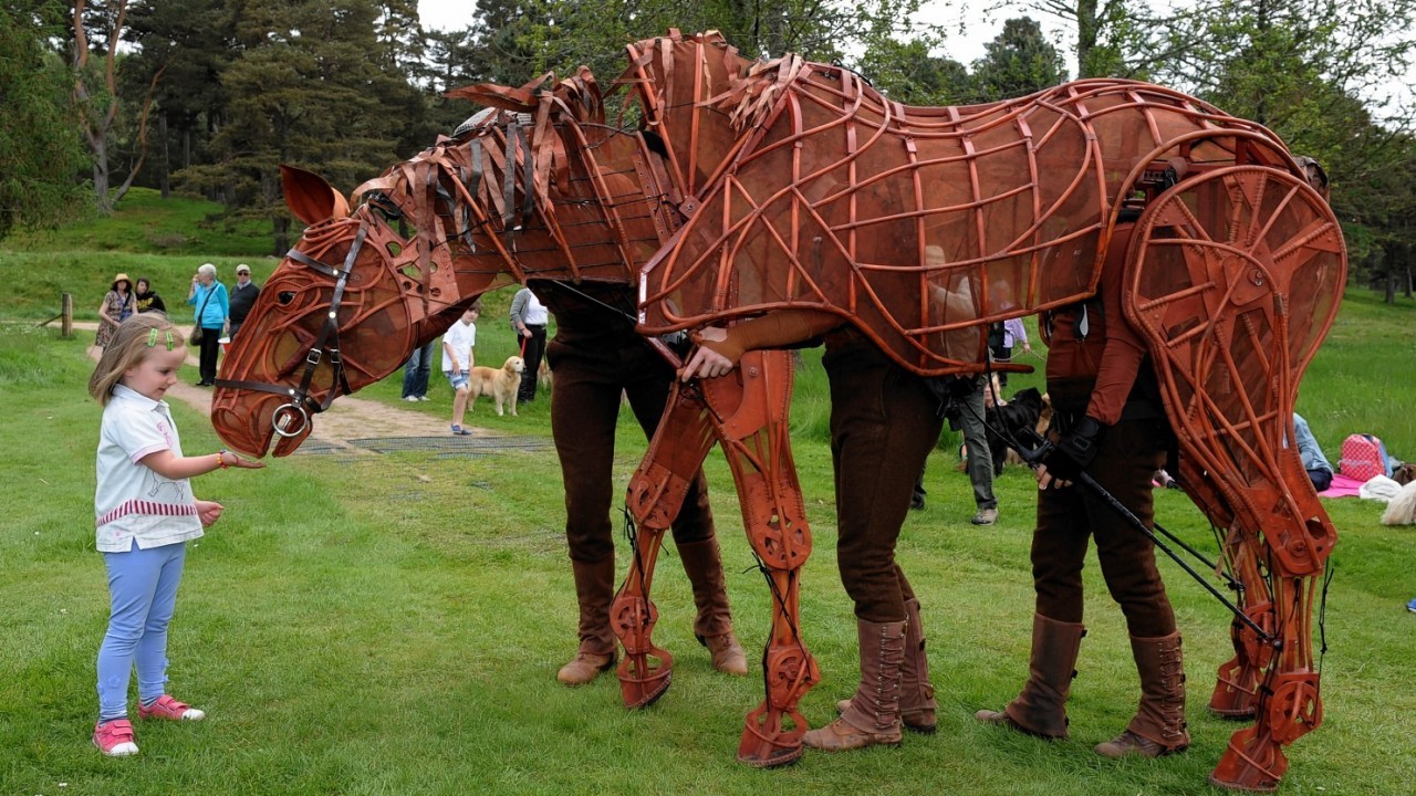 Isla Nicoll, 5, with Joey the huge puppet war horse, from National Theatre's production of War Horse