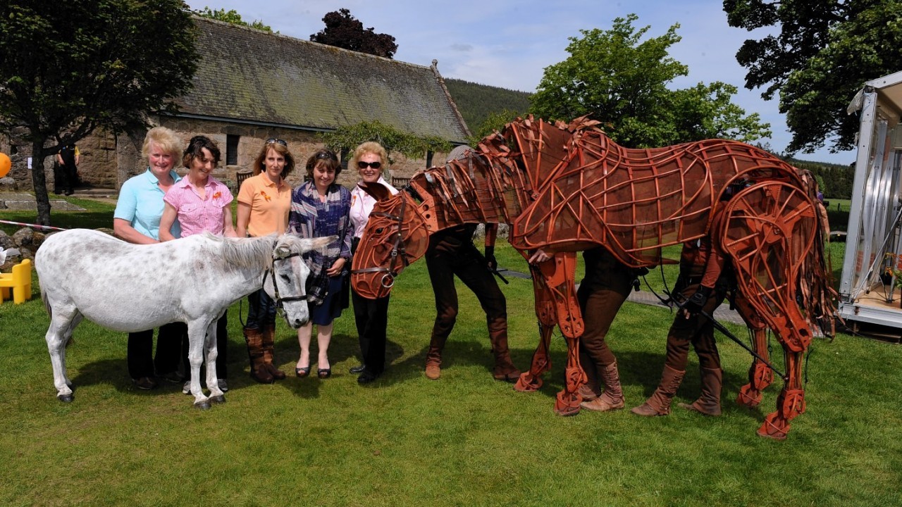 Brooke Supporters group with charity mascot Porridge the donkey and war horse, the huge puppet Joey from National Theatre's production of War Horse.