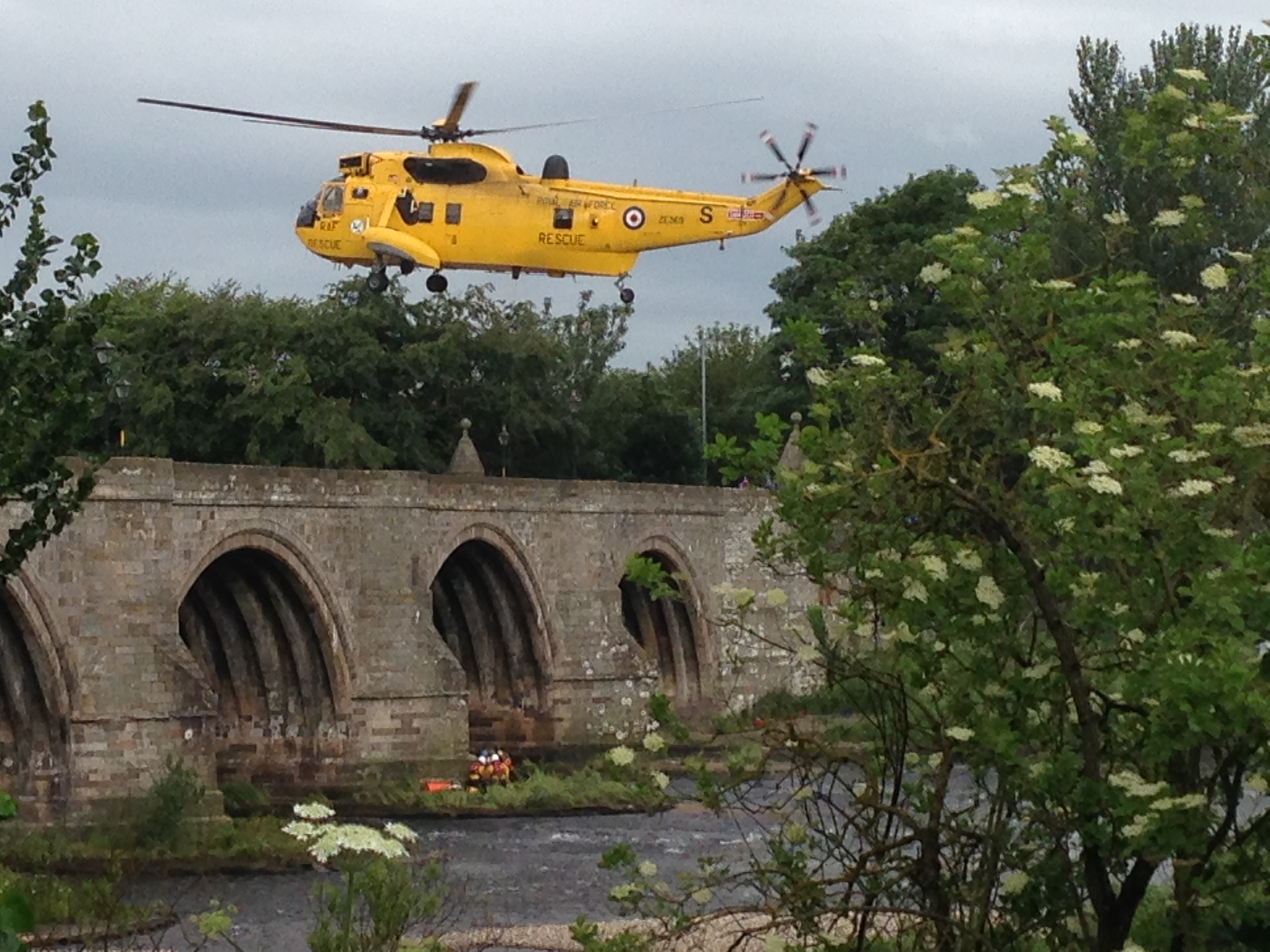 A rescue helicopter lowers to take the woman to safety at the Bridge of Dee. Picture by  David Currie