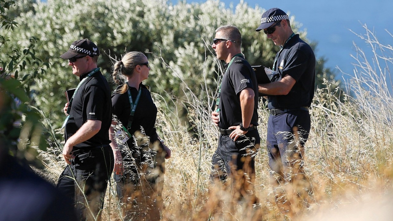 British police search an area of scrubland close to where Madeleine McCann went missing seven years ago, in the resort of Praia da Luz, Portugal