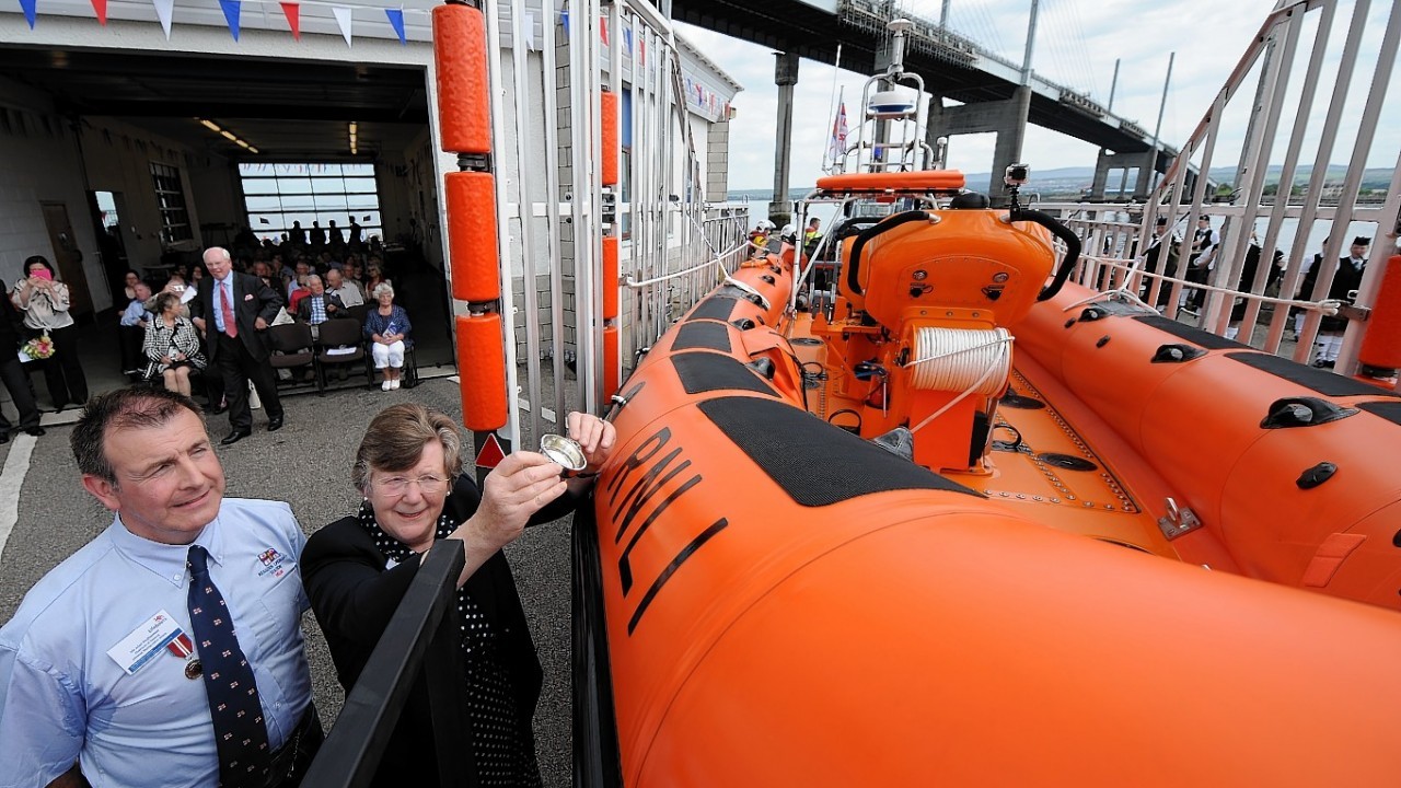 The new North Kessock Lifeboat  the 'Robert and Isobel Mowat' was officially named at a ceremony on Saturday afternoon. Mrs Sheila Percy on behalf of the late Dr Isobel Stewart Fenton pours a dram over the bows of the lifeboat accompanied by Alan MacDiarmid, Chairman of the Kessock Lifeboat Management Group.