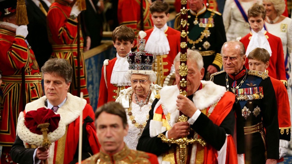 The Queen and the Duke of Edinburgh proceed through the Royal Gallery during the State Opening of Parliament in the House of Lords at the Palace of Westminster in London