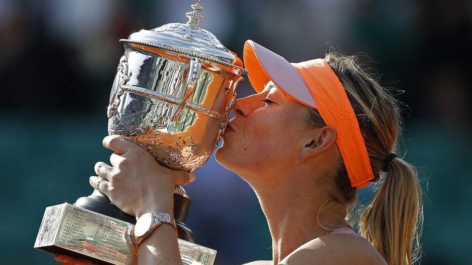 Maria Sharapova kisses the trophy after winning the French Open in a thrilling three-set final (AP)