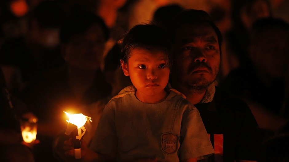Tens of thousands of people attend a candlelight vigil at Victoria Park in Hong Kong to mark the 25th anniversary of the Tiananmen Square crackdown (AP Photo/Kin Cheung)