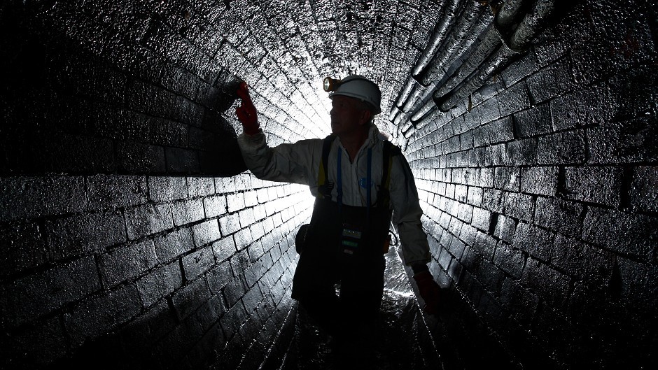 A man inside an underground sewer