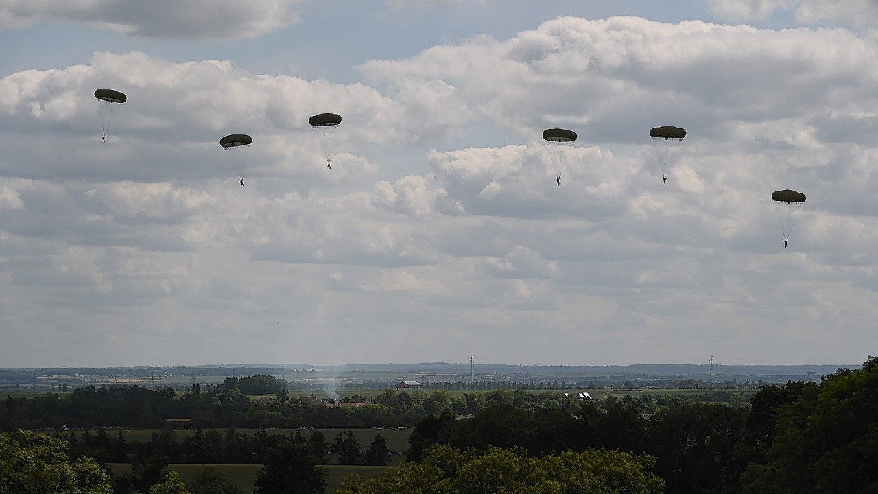 A commemorative parachute drop takes place over wartime Drop Zone N in Ranville, Normandy.