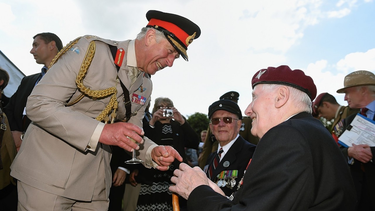 The Prince of Wales meets Normandy veteran Jim Beasant, 91 from Basingstoke, during a reception at Breville Les Monts in Normandy, France.