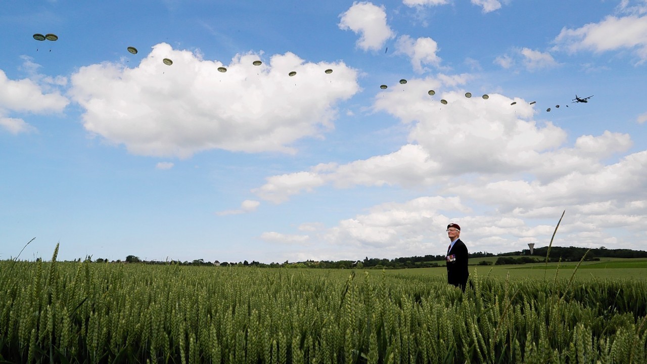 A commemorative parachute drop takes place over wartime Drop Zone N in Ranville, Normandy.