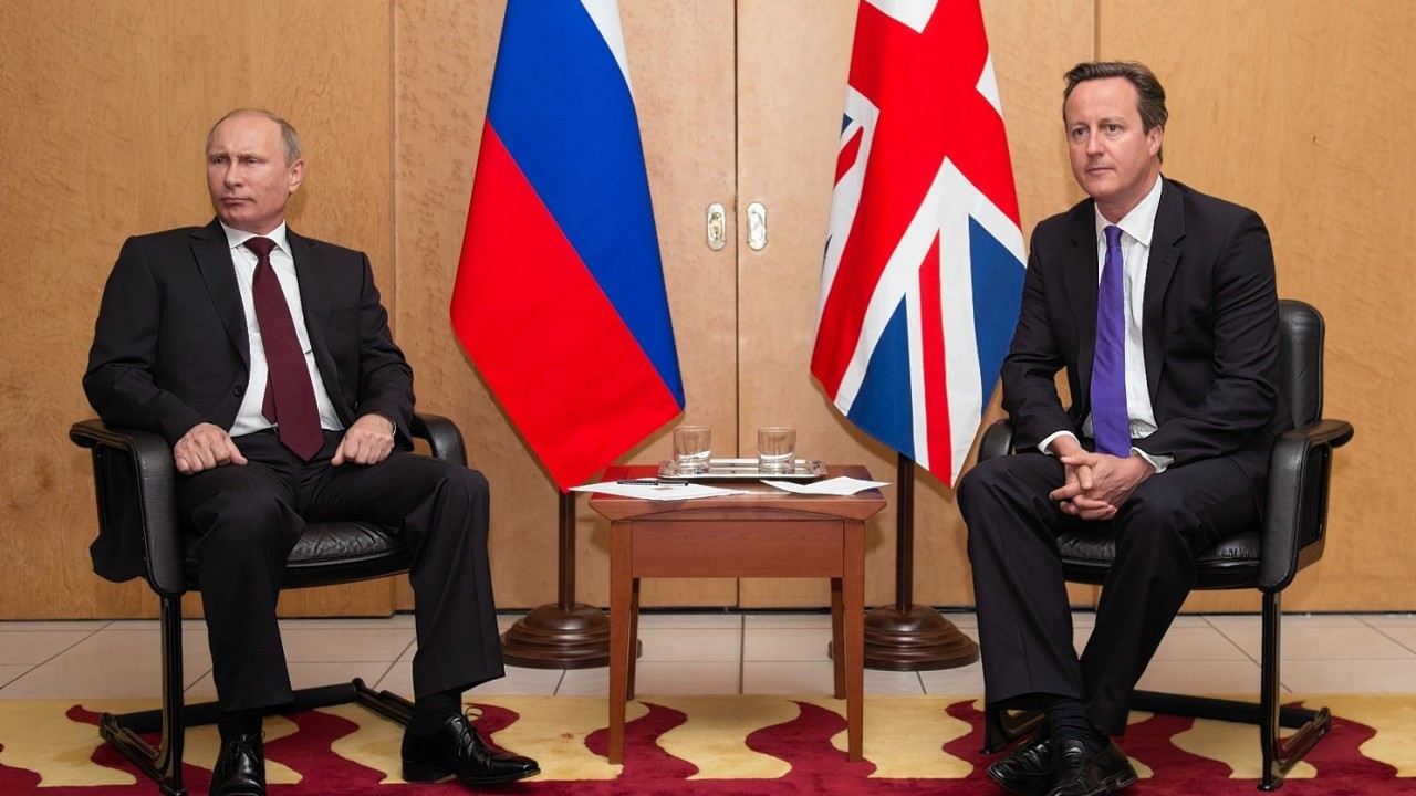 British Prime Minister David Cameron meets with Russian President Vladimir Putin (left) at Charles De Gaulle Airport in Paris, as they travelled to France ahead of the 70th anniversary D-Day commemorations