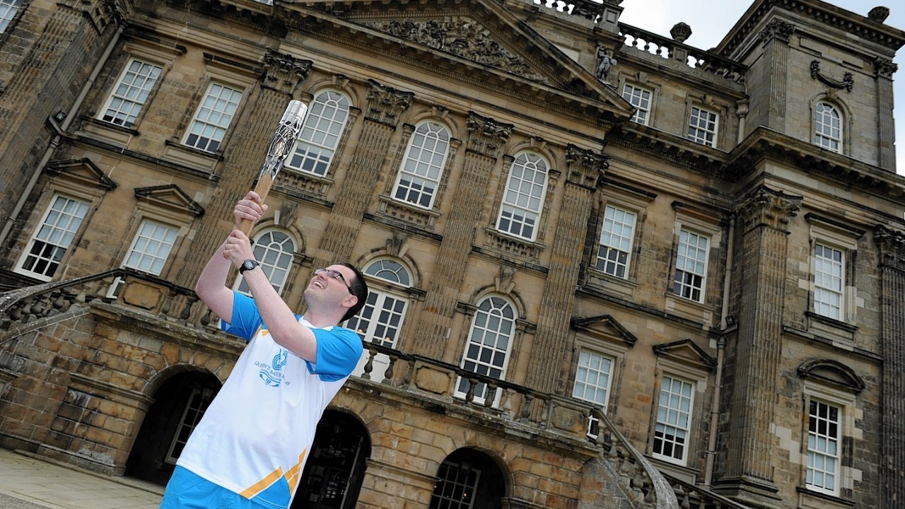 The Glasgow 2014  Commonwealth Games Queens Baton Relay.
Batonbearer Grant Campbell carrying the Queen's Baton at Duff House in Banff.