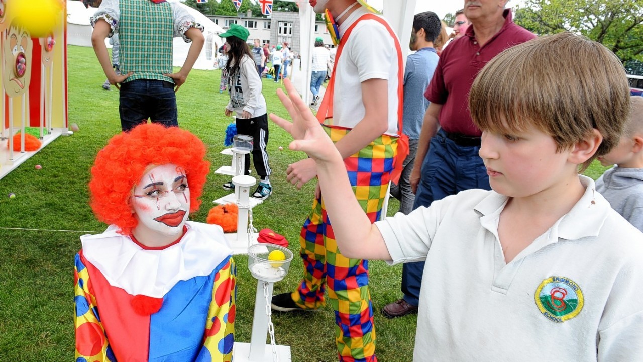 The Rotary Clubs, Kids Out day, at SRUC Craibstone , Aberdeen. In the picture is Jake Milne, Brimmond School with clown and helper, Abbie Houston, S6 Westhill Academy.