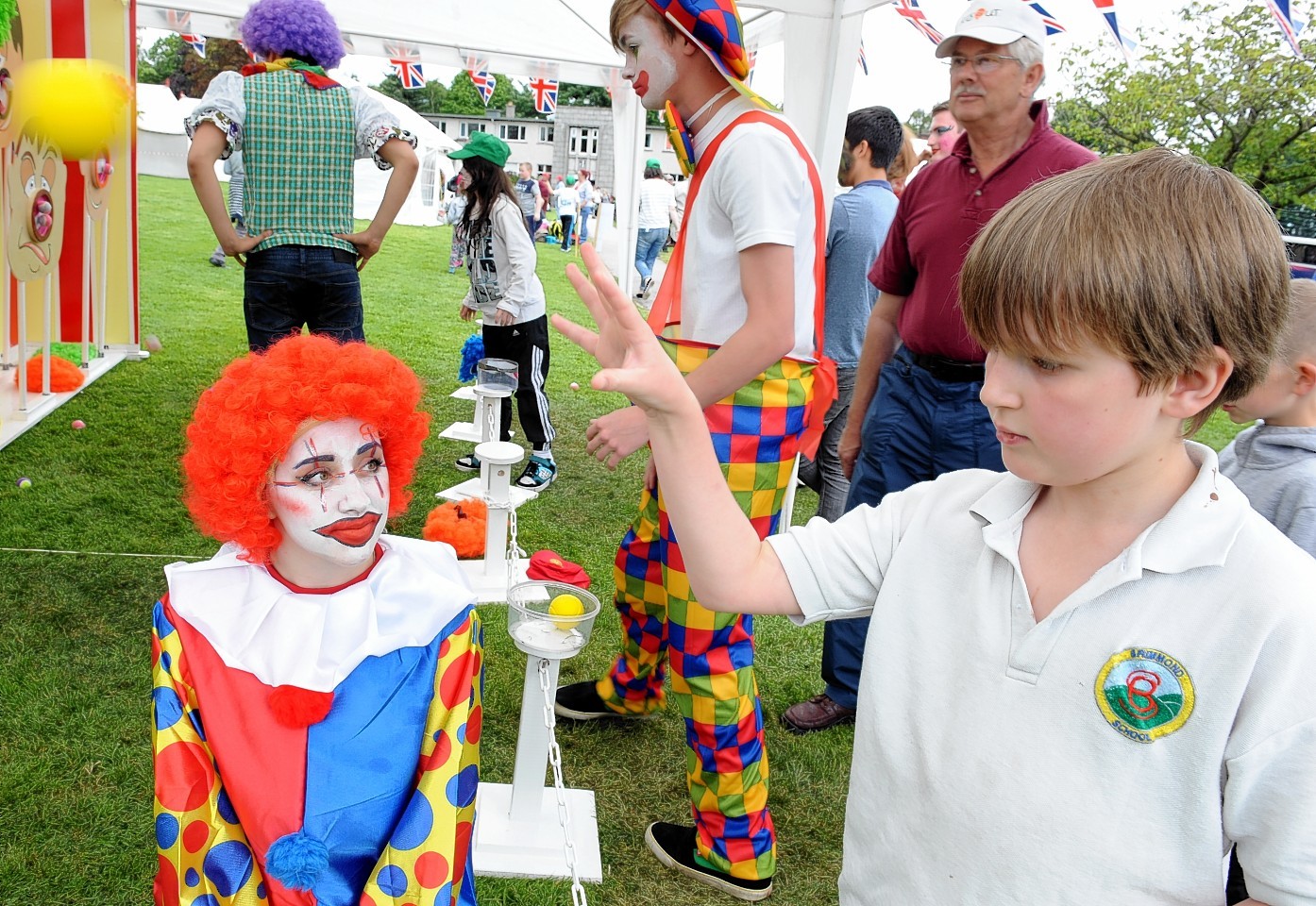 The Rotary Clubs, Kids Out day, at SRUC Craibstone , Aberdeen. In the picture is Jake Milne, Brimmond School with clown and helper, Abbie Houston, S6 Westhill Academy.