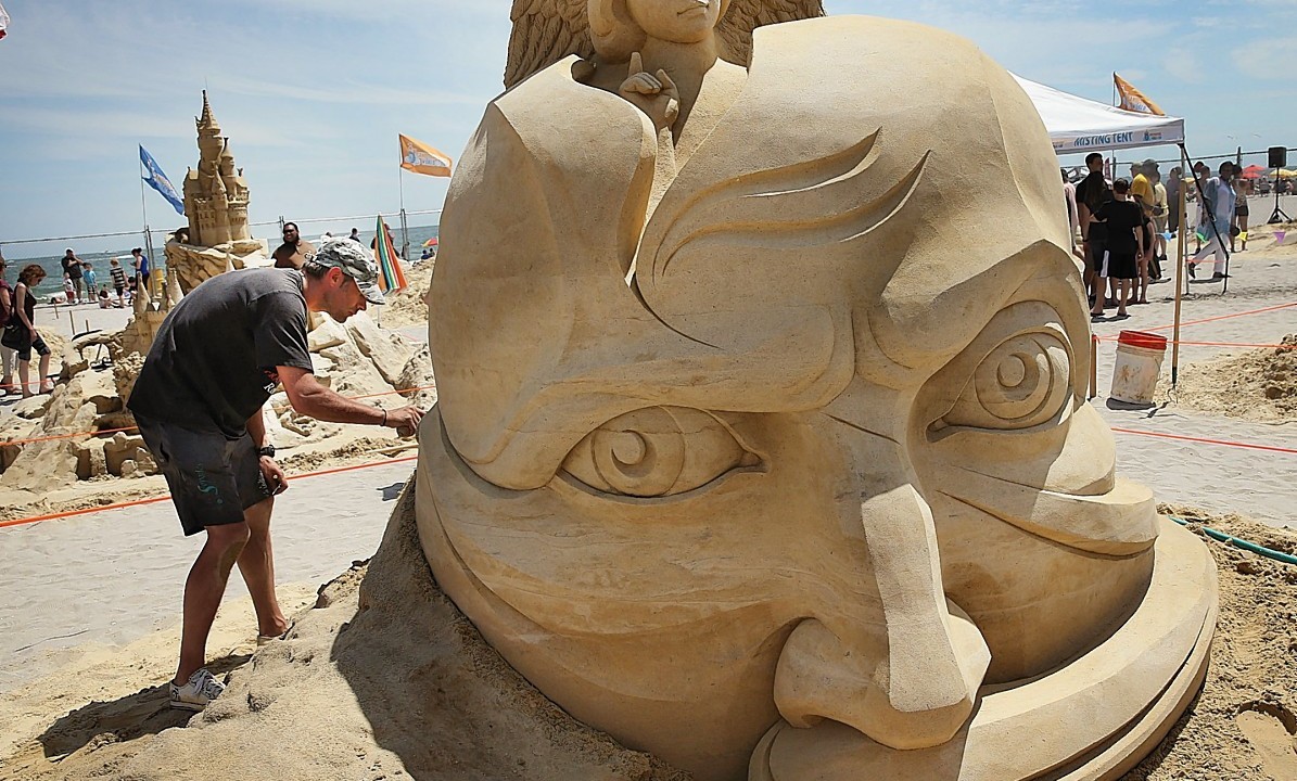Sculptor Aleksei Diakov, of Russia, details his sculpture. during the final day of the DO AC Sand Sculpting World Cup competition on the beach at Pennsylvania Avenue in Atlantic City