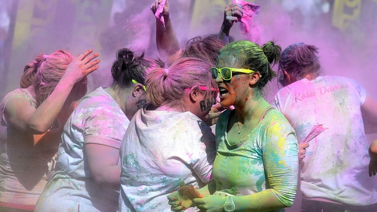 Participants take part in the Color Me Rad 5km run at Ingleston in Edinburgh where the runners are blasted with bombs of different colours during the race.