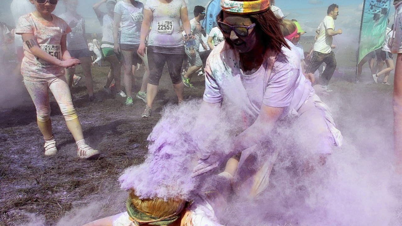 Participants take part in the Color Me Rad 5km run at Ingleston in Edinburgh where the runners are blasted with bombs of different colours during the race.