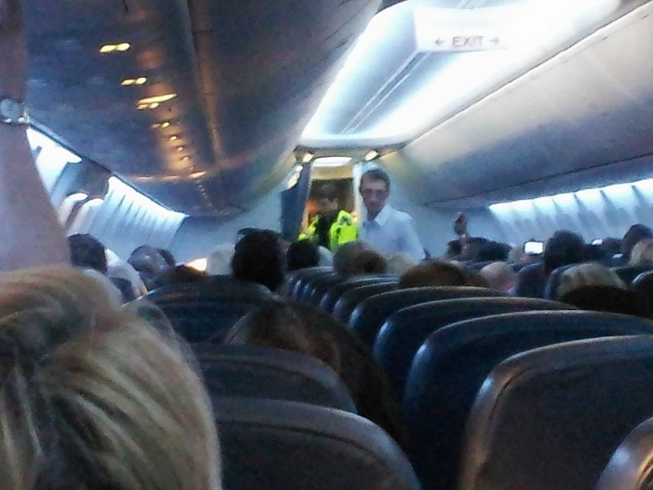 Police enter the aircraft after it was diverted to London