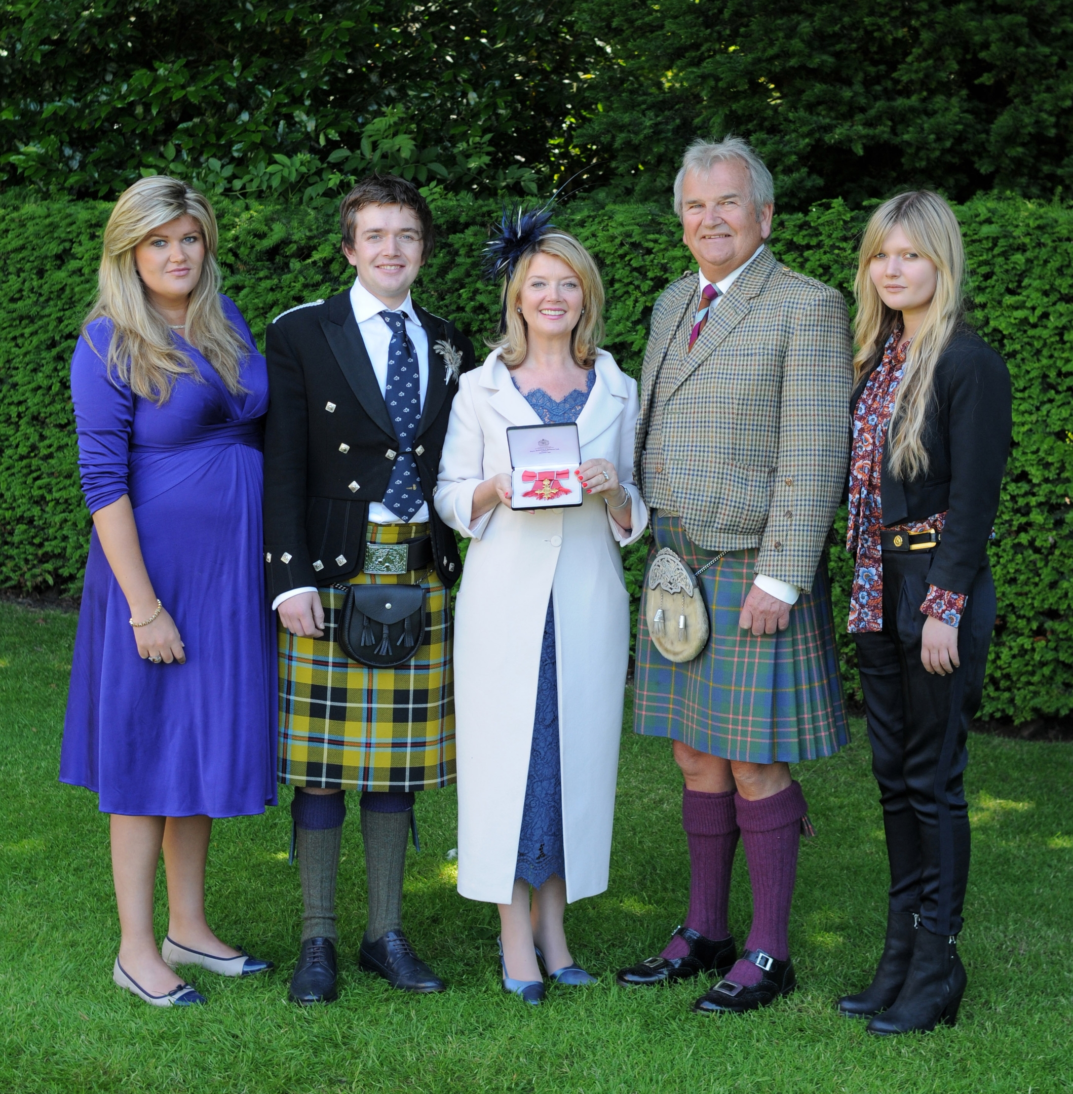 Dr Fiona Kennedy, pictured with her family after she received her OBE from Queen Elizabeth II at the Palace of Holyroodhouse in Edinburgh. OBE. Picture date: Tuesday 1 July 2014. Copyright: Palace Photos