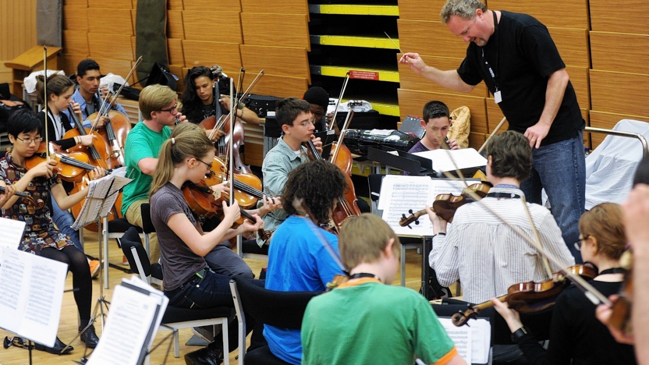 Jeffrey Grogan leads the Youth Orchestra during a rehearsal. Credit: Colin Rennie.