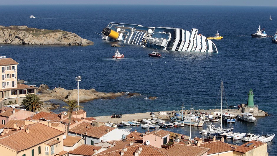 The wreck of the luxury cruise ship Costa Concordia is held up by giant tanks as tug boats surround it in the final stages of the refloating phase before being towed to the Italian port of Genoa, in the tiny Tuscan island of Isola del Giglio, Italy,