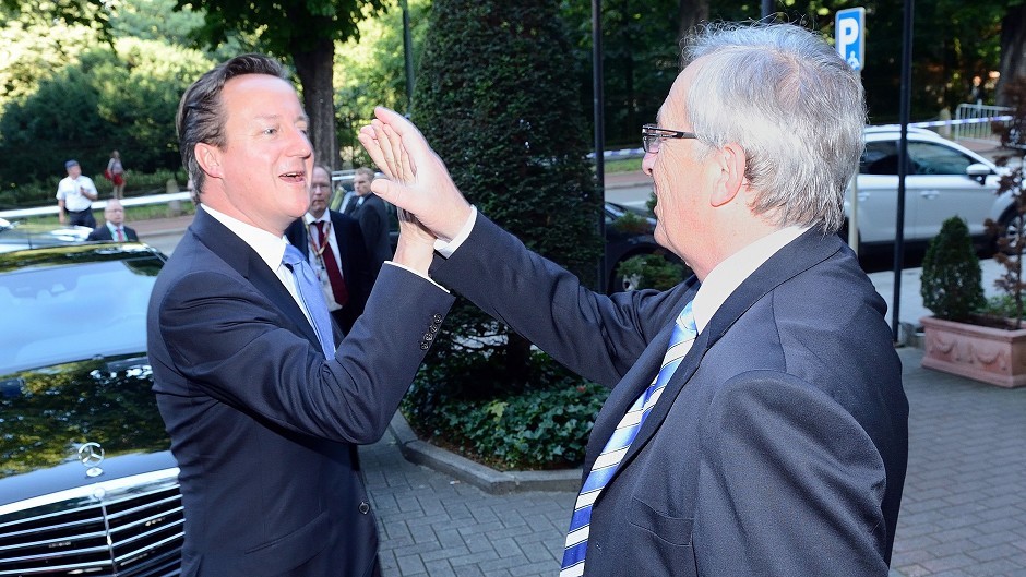 Jean-Claude Juncker "high-fiving" Prime Minister David Cameron at the European Parliament in Brussels, Belgium.